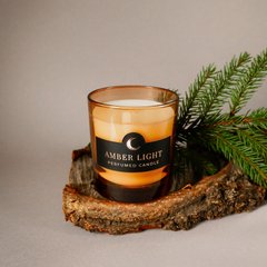 Парфумована свічка "Amber Light" у помаранчевій склянці